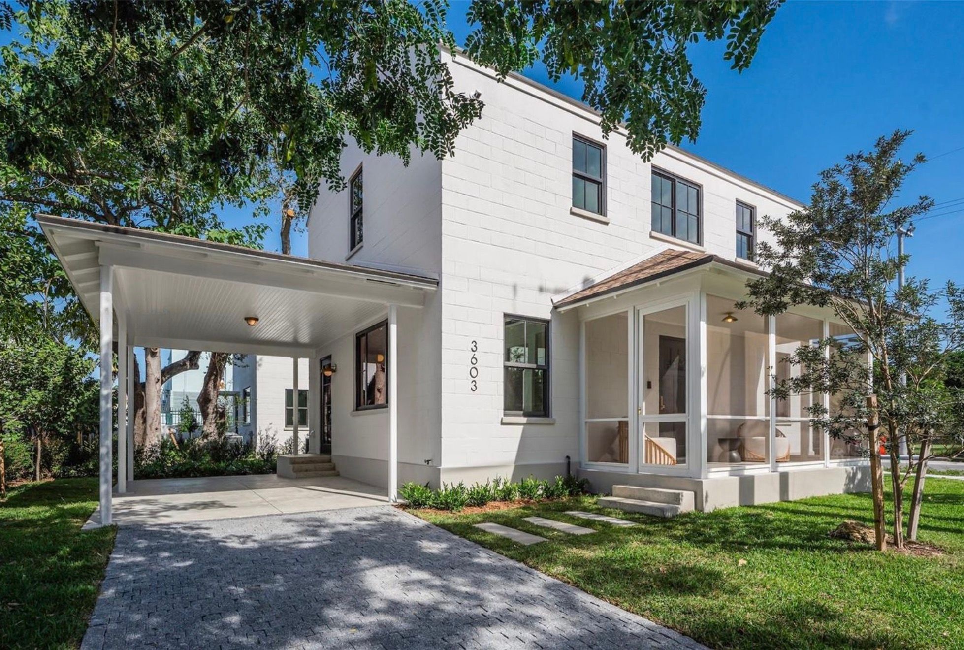 White brick exterior with carport and screened porch