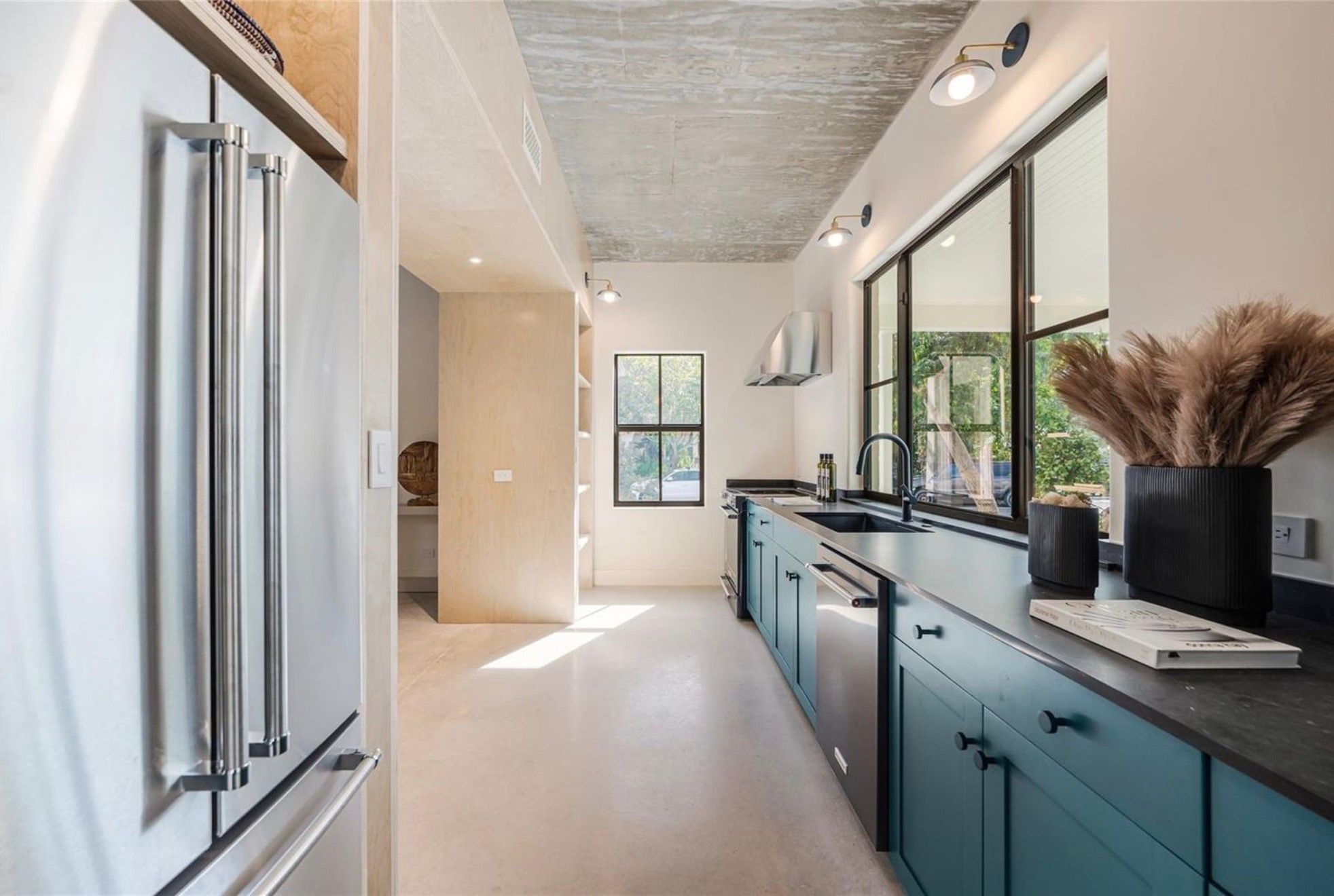 Galley kitchen in petrol green with soapstone counters